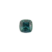 1.42ct cushion cut Montana sapphire with teal blue and peacock green hues, polished and sparkling under light.