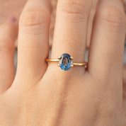 1.39ct Oval Cut Teal Blue Montana Sapphire ring with gold band, authentic and ethically sourced from Montana USA.