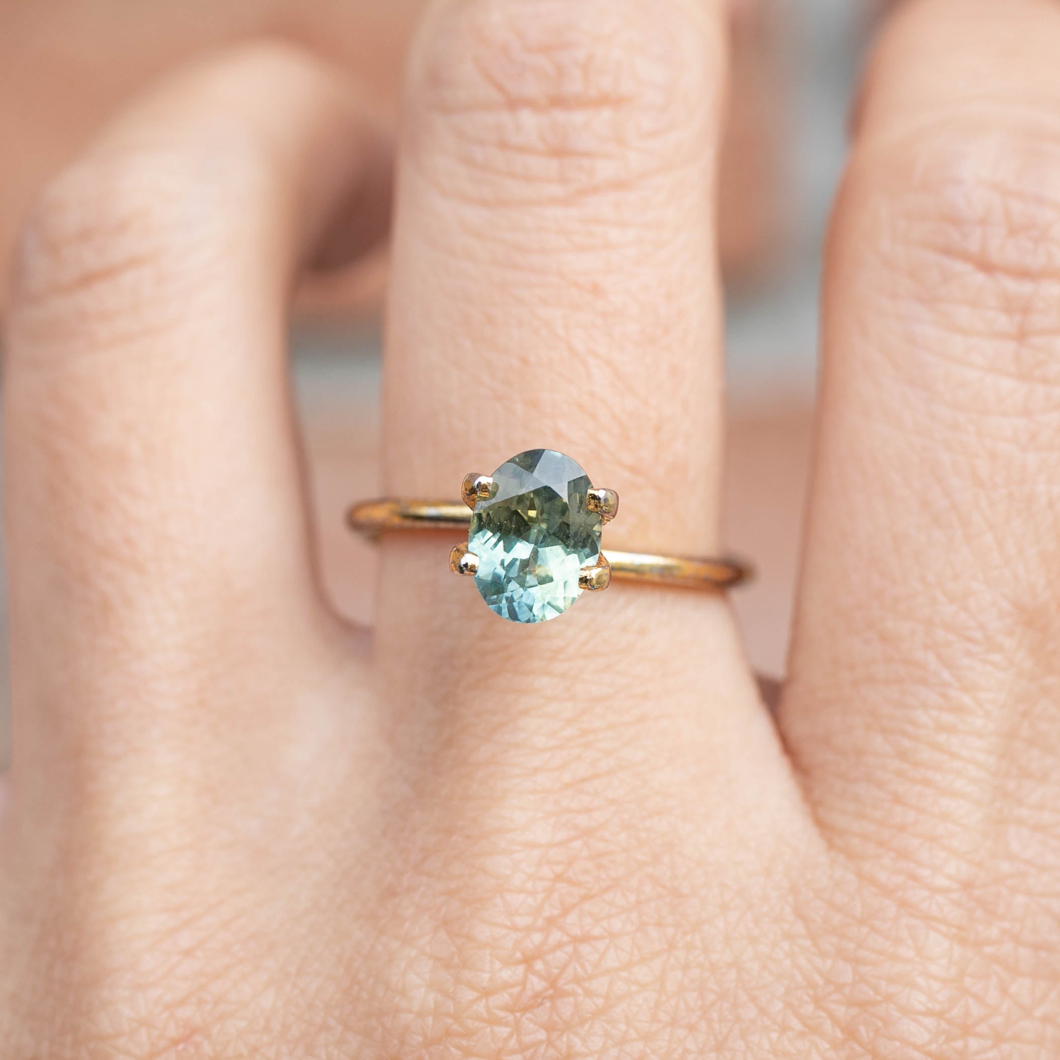 1.61ct Oval Cut Parti Aqua Green & Lime Green Montana Sapphire ring on finger, handmade authentic jewelry