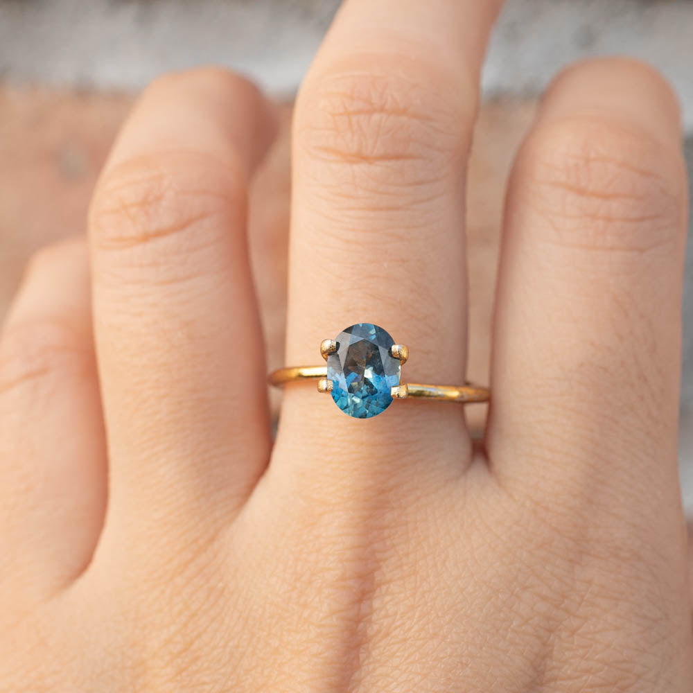 1.89ct Oval Cut Parti Blue Green Sapphire ring on finger, handmade and ethically sourced from Montana, USA by Envero Jewelry