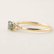 14k yellow gold ring with 4.5mm green Montana sapphire and small natural accent diamonds in flower setting