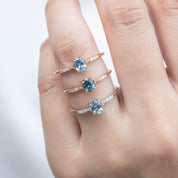 3 Eloise Ring with a 0.45ct unheated oval sapphire and diamond pave band in 14k yellow gold, rose gold, white gold on the hand.